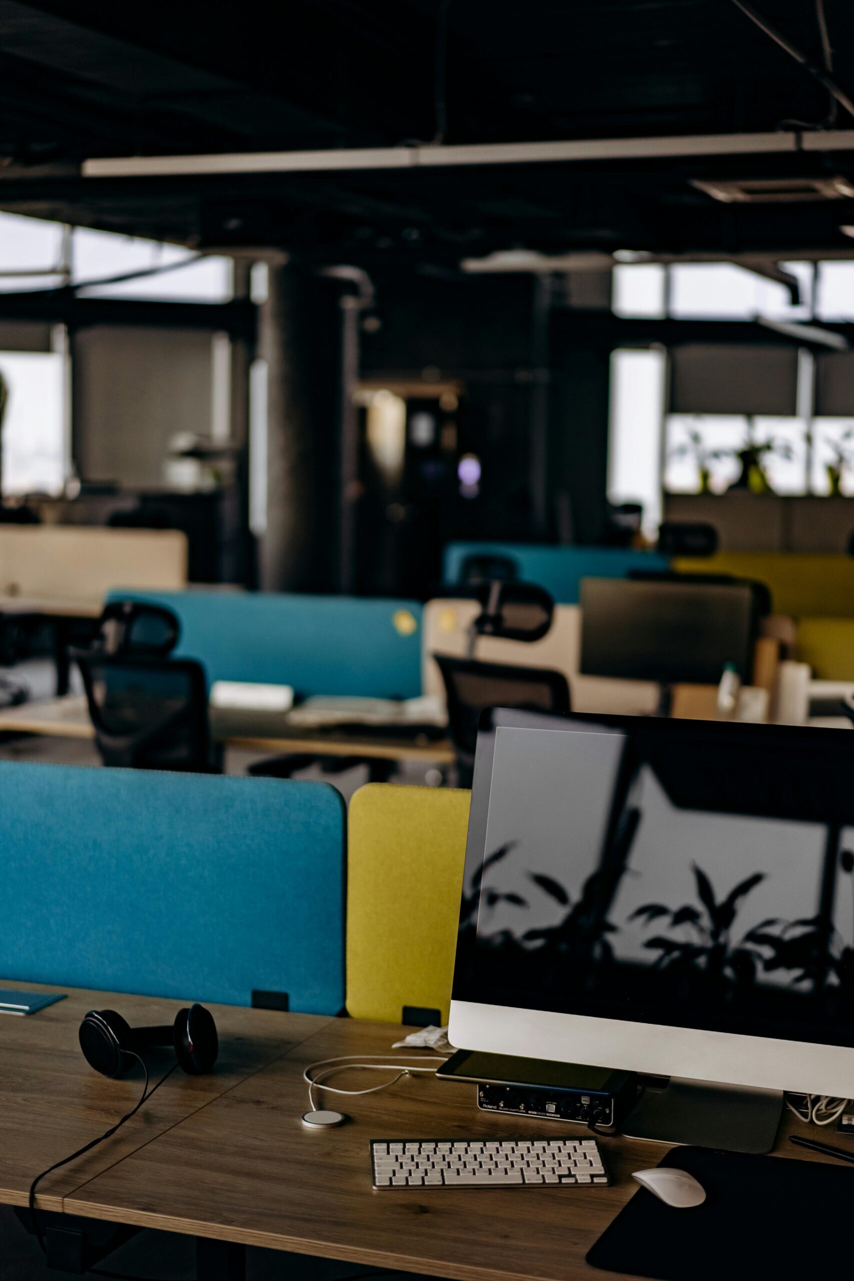 Open office space with computers and colorful partitions, perfect for modern work settings.