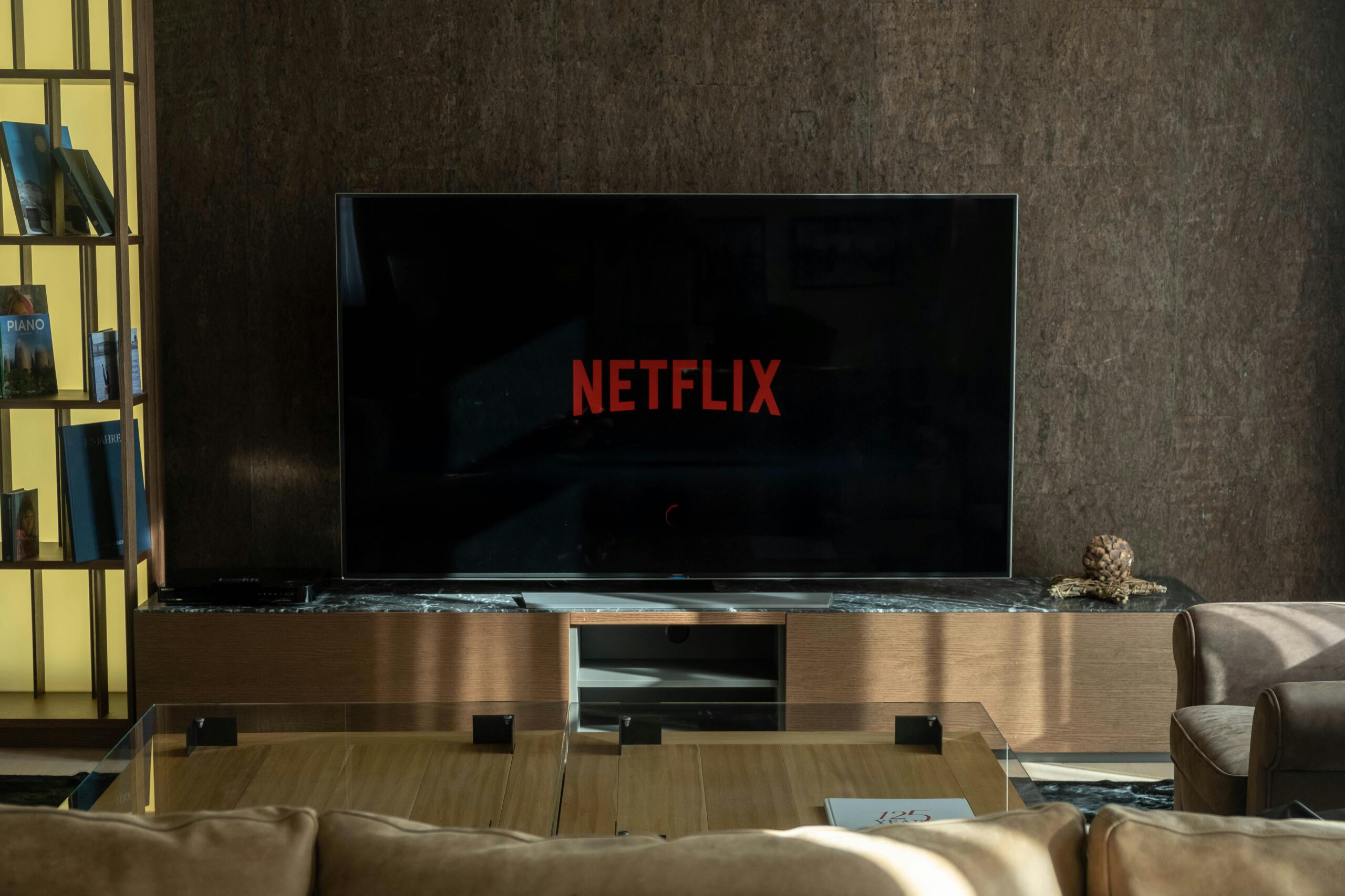 Cozy living room featuring a large TV displaying Netflix, perfect for entertainment.