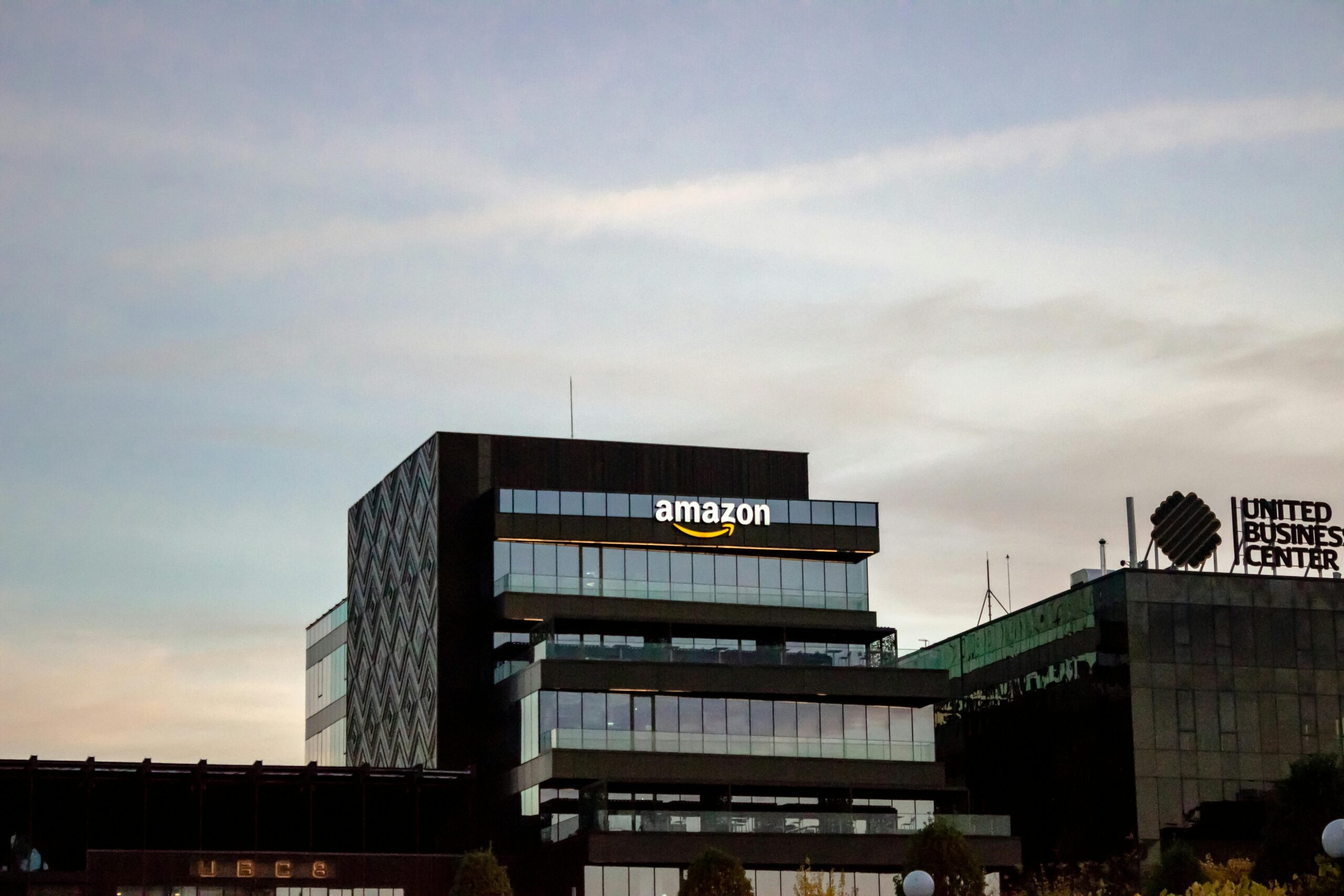 Contemporary architecture showcasing Amazon office at dusk in Iași, Romania.