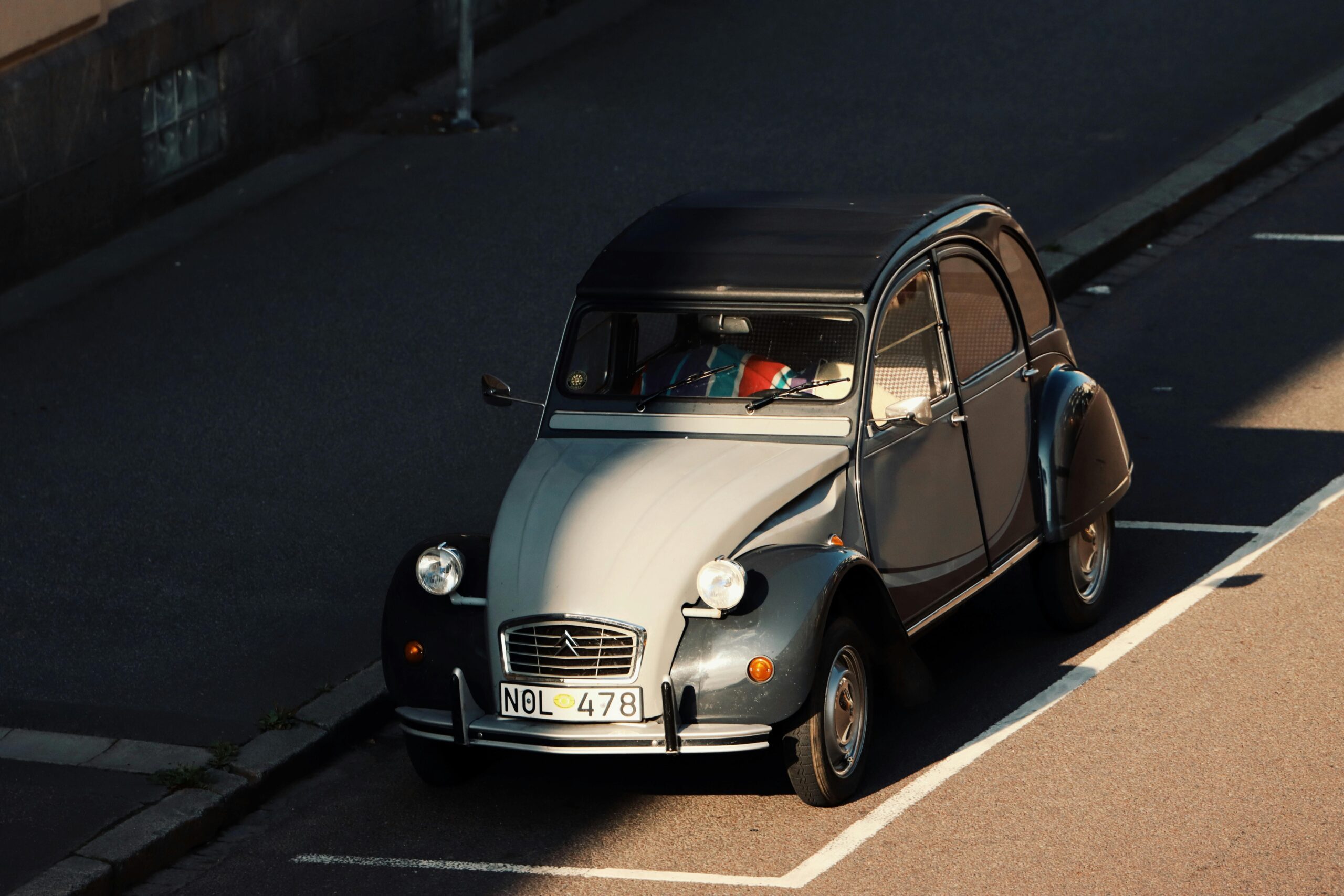 Vintage Citroën 2CV parked on a street in Jönköping, Sweden, capturing retro automotive charm.