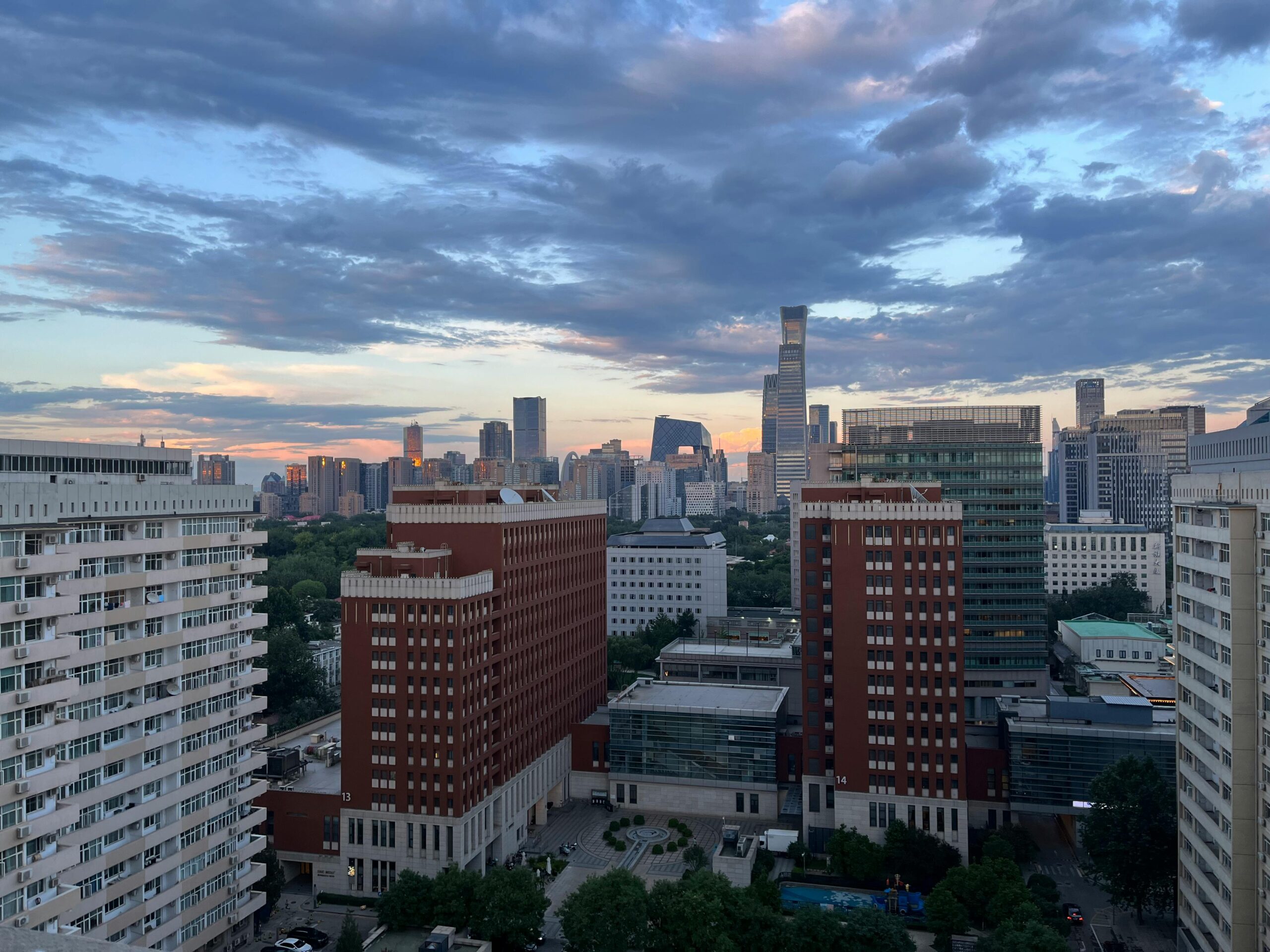 A stunning evening view of Beijing's skyline featuring modern skyscrapers and vibrant sunset colors.