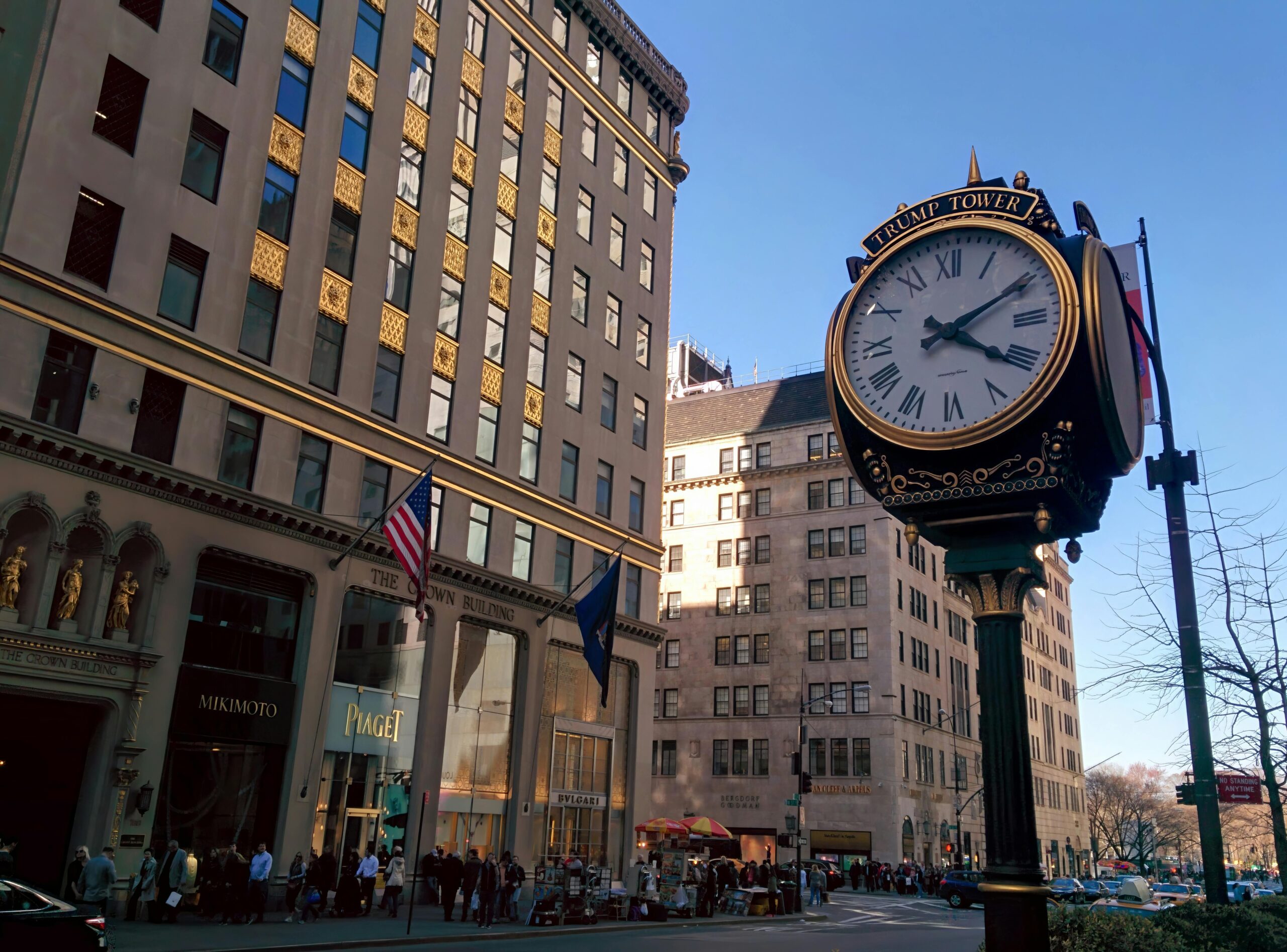 Street view of New York City featuring a classic clock tower against urban architecture.