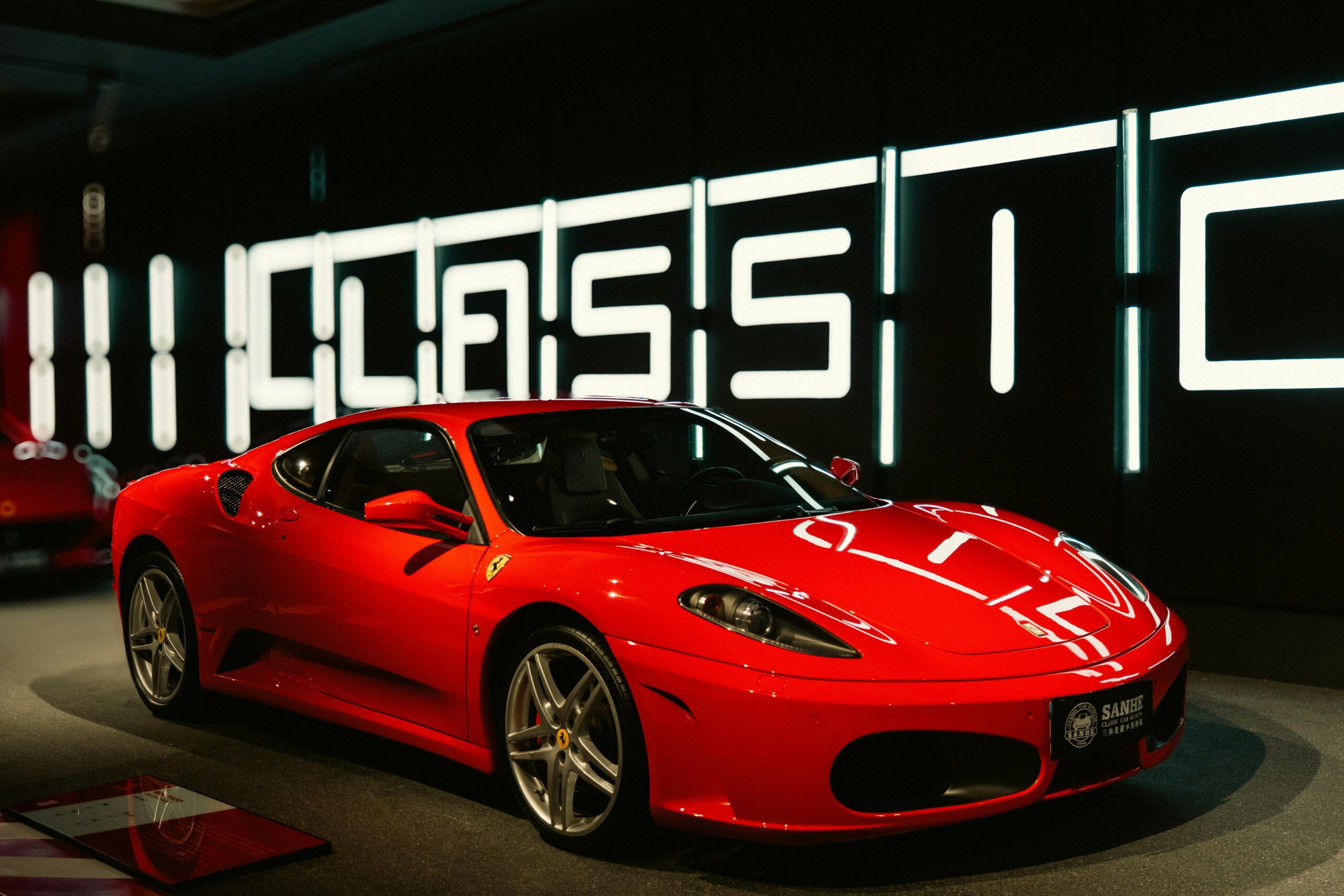 Vibrant red sports car displayed in a modern and stylish showroom with classic design.