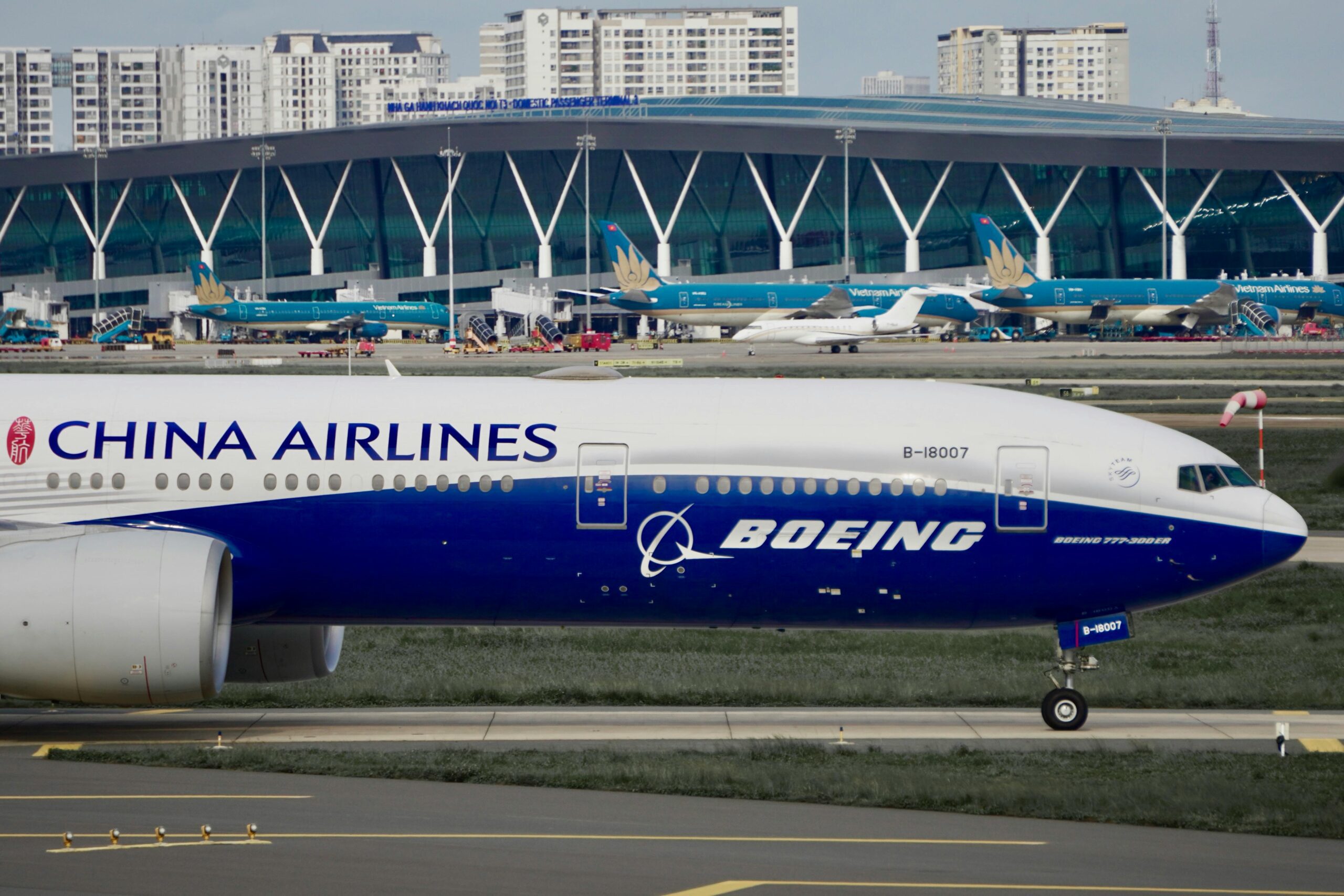 Close-up of a Boeing 777 by China Airlines taxiing at an airport terminal.