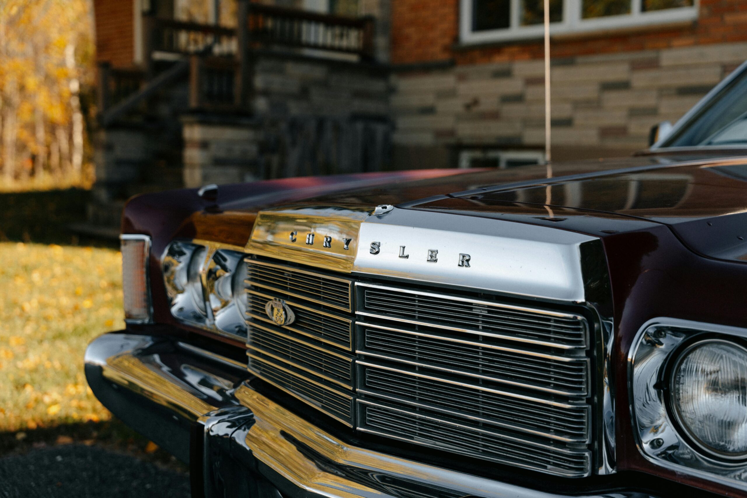 Close-up of a vintage Chrysler car front in an autumn setting at North Hatley.