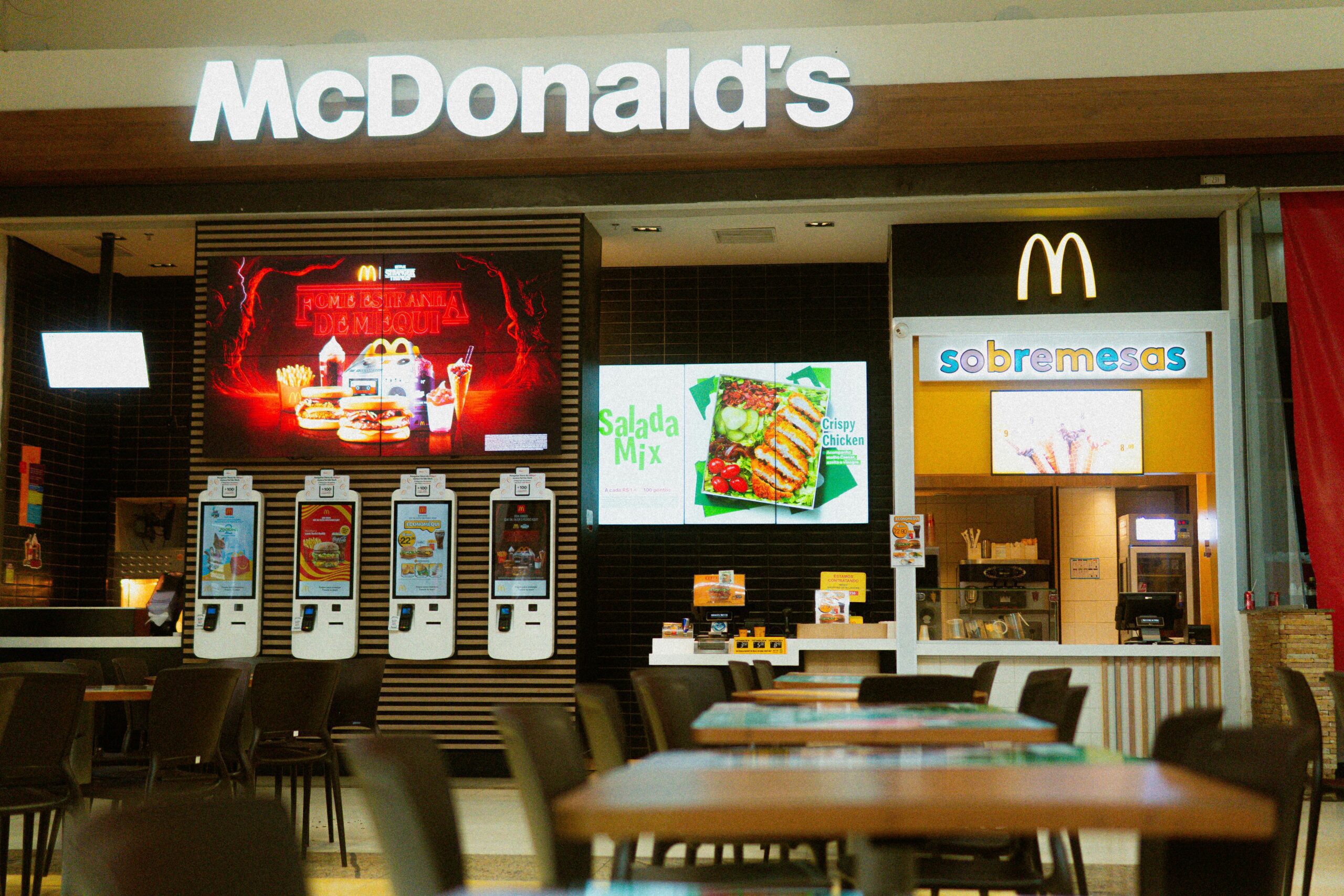 McDonald's fast food restaurant featuring self-service kiosks and digital menus.