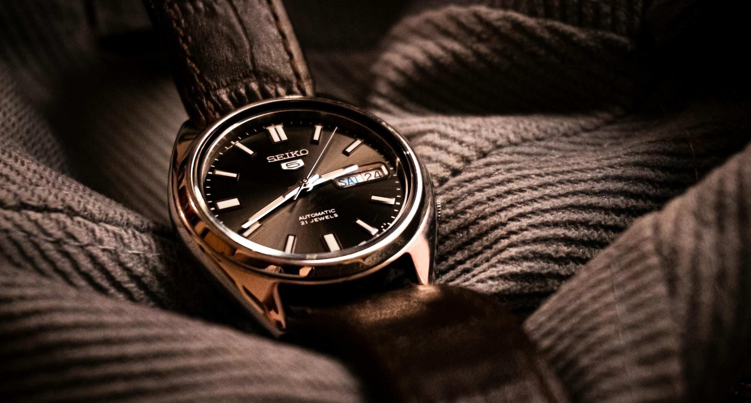 Close-up of a Seiko wristwatch on a textured fabric. Perfect for timepiece enthusiasts.