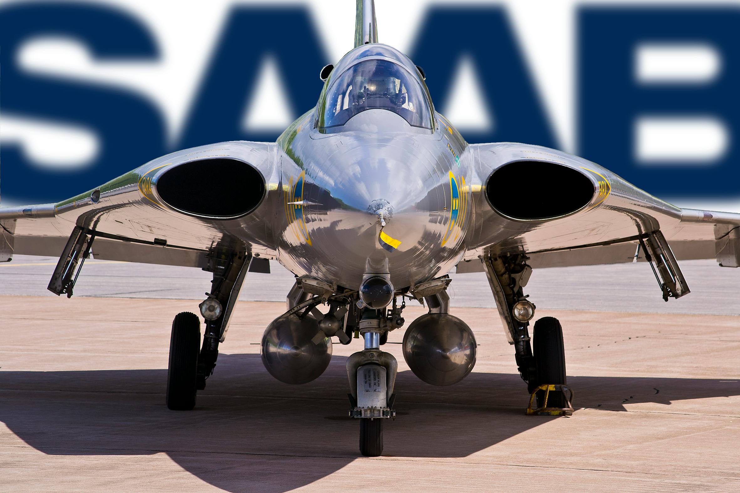 Close-up of a J 35 Draken fighter jet, showcasing its sleek design and parked under a SAAB logo.