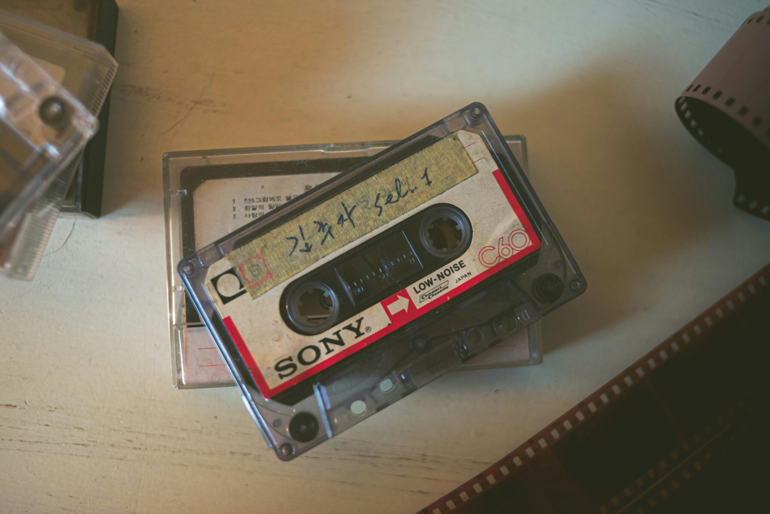 Close-up of a vintage Sony cassette tape on a wooden surface, evoking nostalgia.