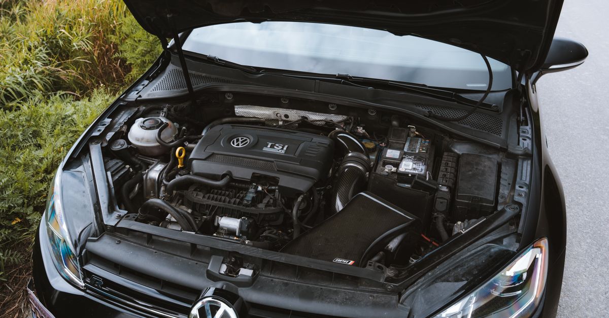 Close-up view of a Volkswagen car engine with the hood open, showcasing detailed components.