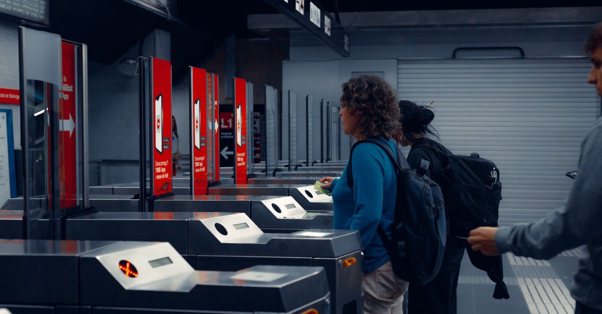 Urban commuters using turnstiles at a modern subway station, showcasing daily public transportation routine.