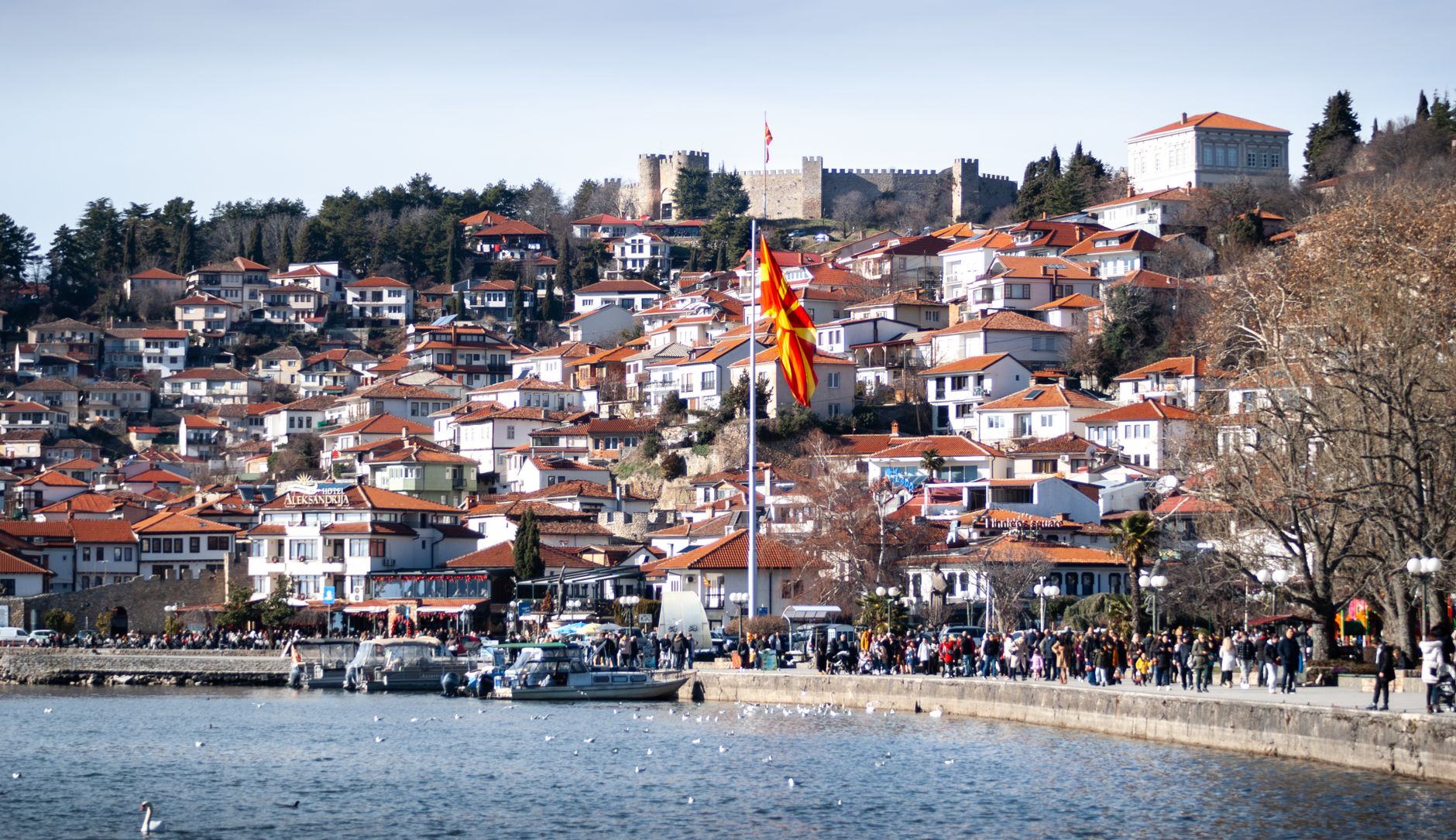 Beautiful Ohrid landscape with traditional buildings and Macedonian flag.
