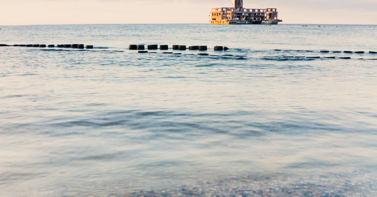 Serene seascape of Gdańsk with a distant historic building in the Baltic Sea.