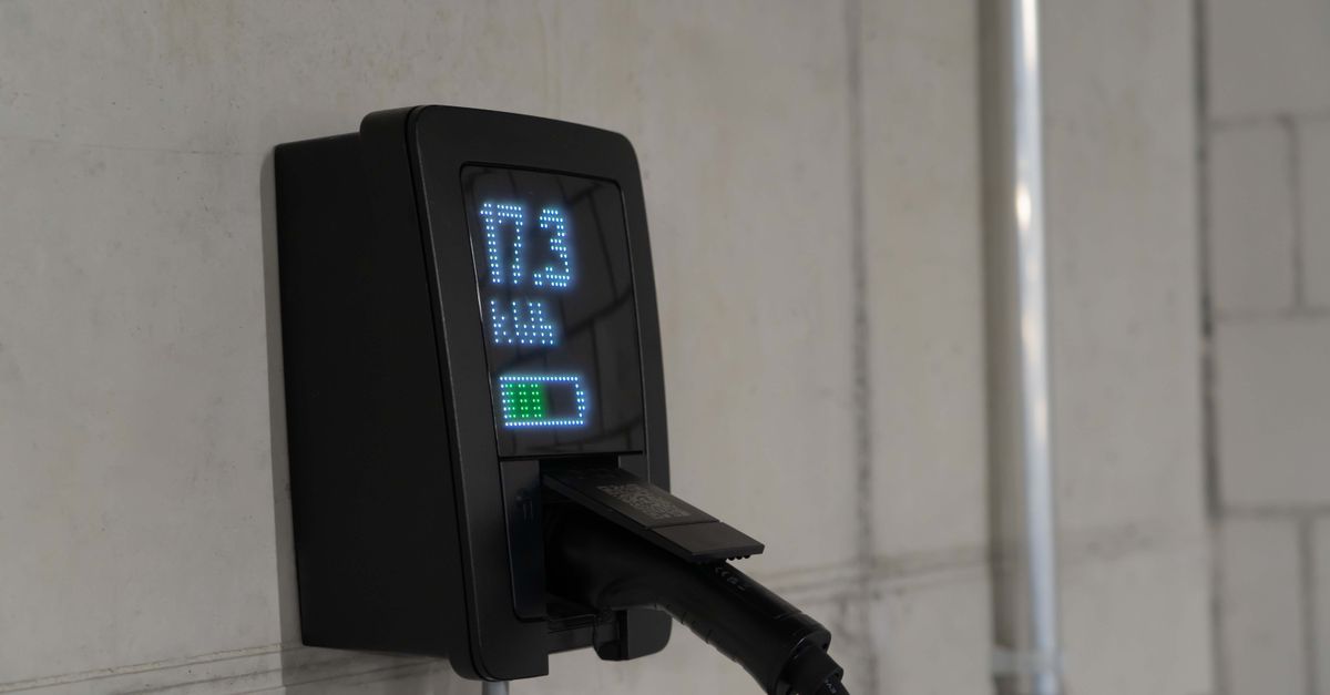 Detailed view of an electric vehicle charging station indoors, showcasing charging technology.