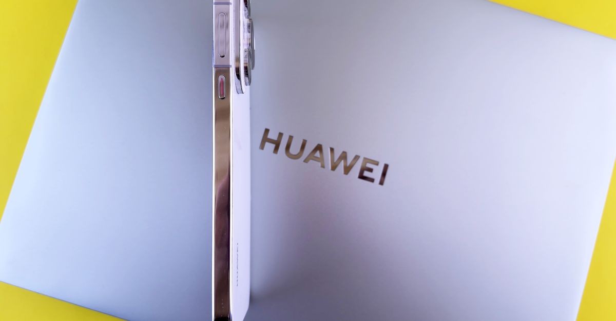 Side view of a smartphone placed on a laptop featuring the Huawei logo on a vibrant yellow background.
