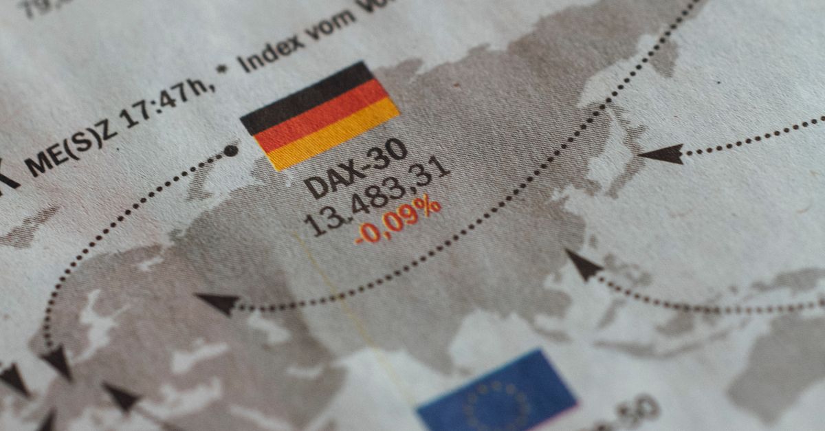 From above of business newspaper with trading indexes and flags of Germany France and European Union