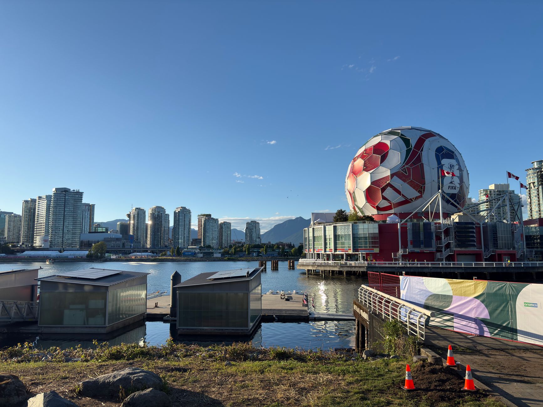 View of Vancouver skyline featuring Science World and a giant soccer ball at sunset.