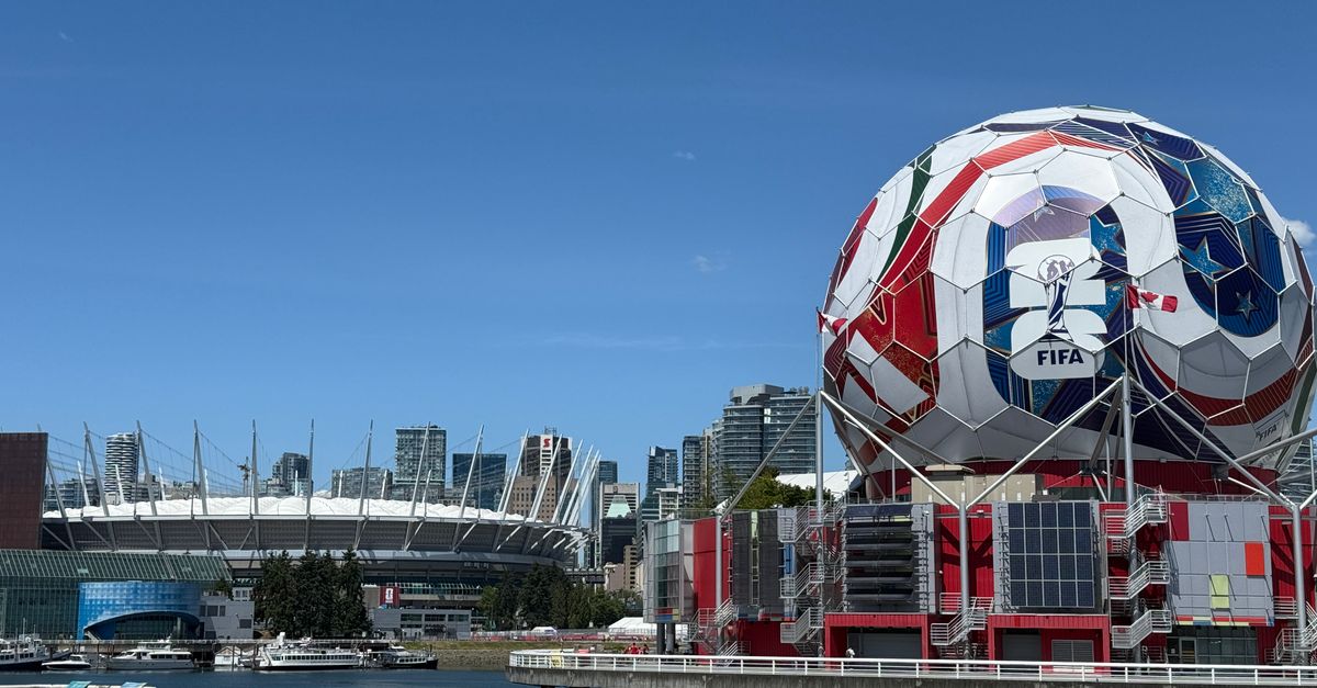 Iconic FIFA soccer ball and Vancouver stadium, showcasing urban sports architecture.