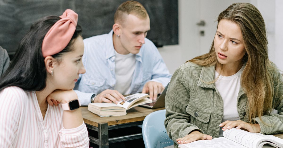 High school students actively engaged in a thoughtful classroom discussion.
