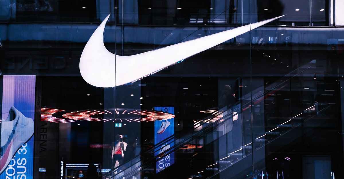 Stylish architectural facade featuring illuminated signage and glass panels, capturing a modern vibe.