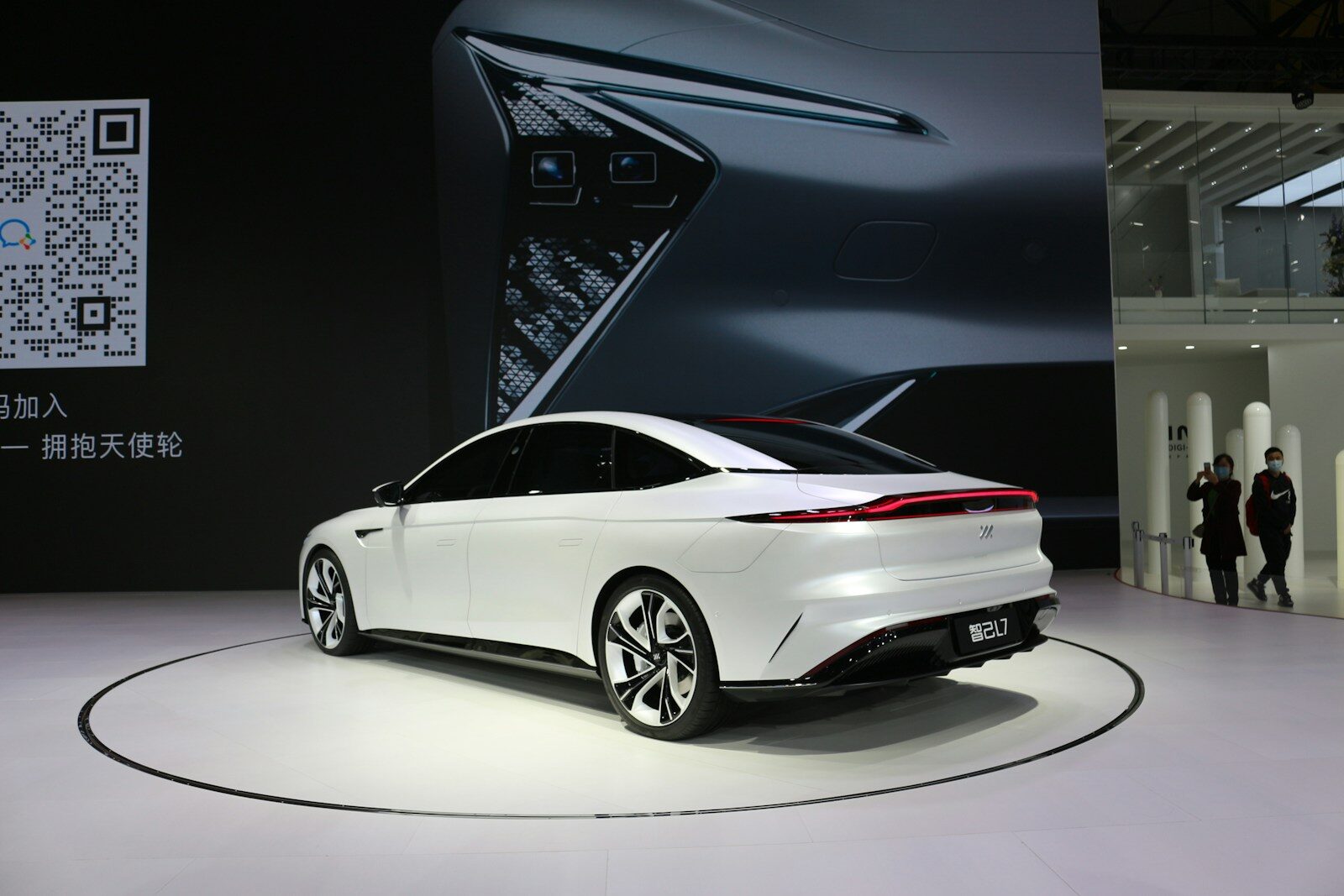 a white car is on display at a show