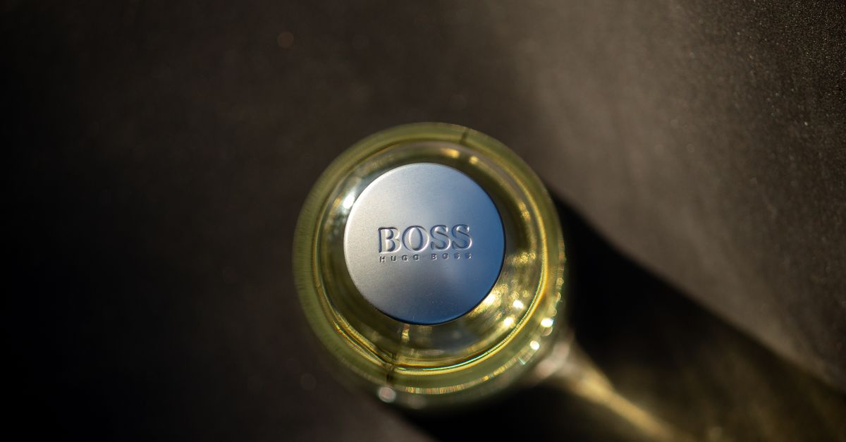 Captivating top view of an elegant perfume bottle casting a stylish shadow in natural sunlight.