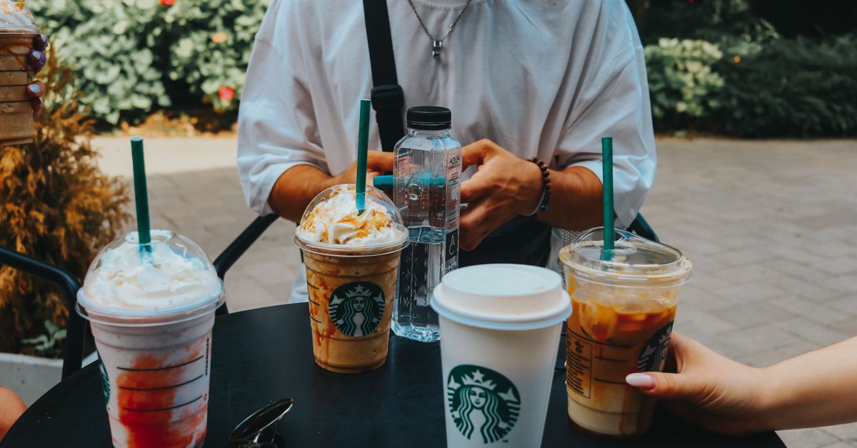 A group enjoying Starbucks coffee outdoors, capturing casual social moments.