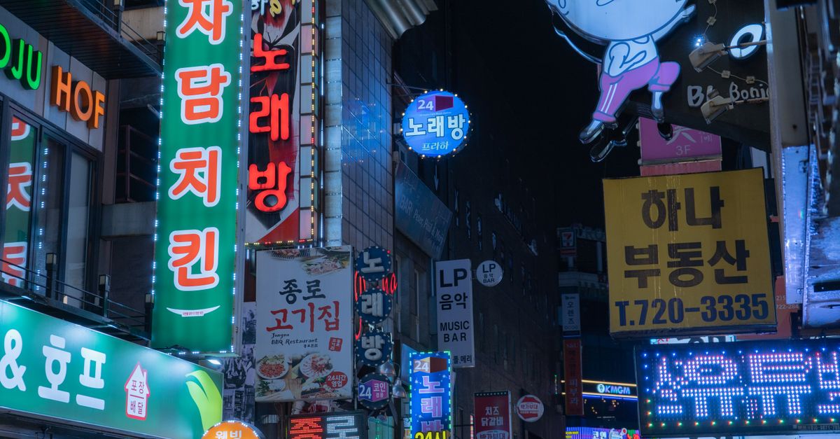 Bright neon lights and bustling night scene in downtown Seoul, Korea.