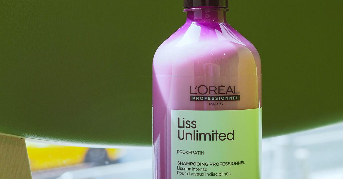 Close-up of L'Oreal Liss Unlimited shampoo in natural lighting, ideal for hair care visuals.