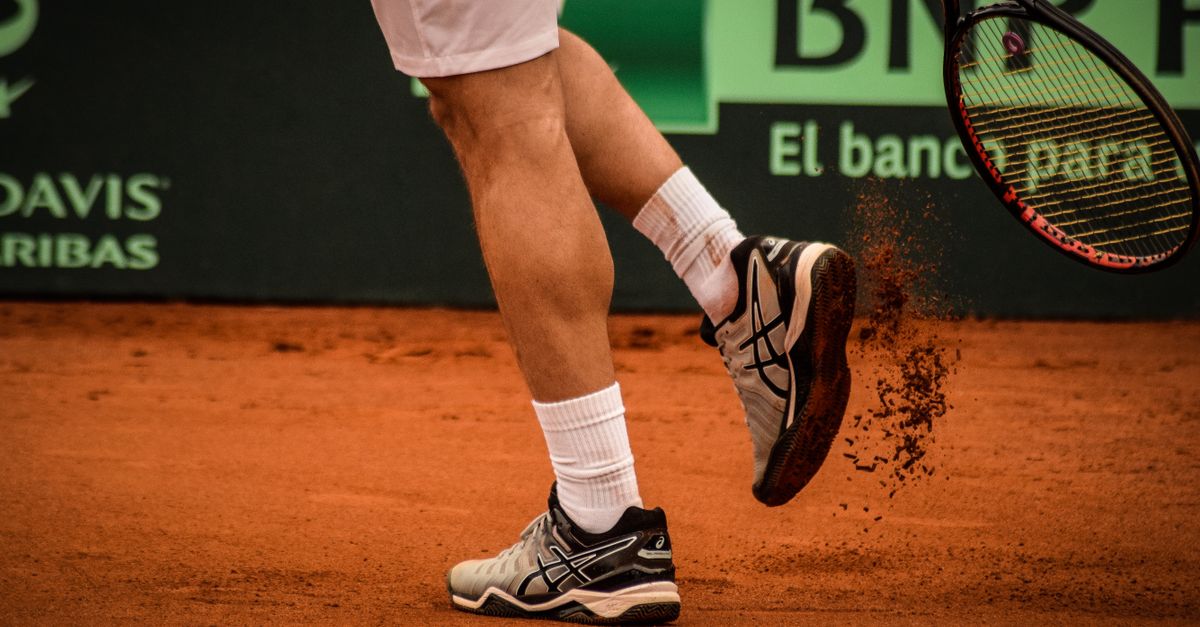 Close-up of a tennis player on a clay court in Montevideo, showcasing movement and energy.