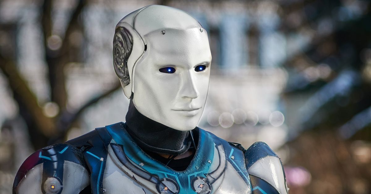 Close-up of a futuristic humanoid robot with metallic armor and blue LED eyes.