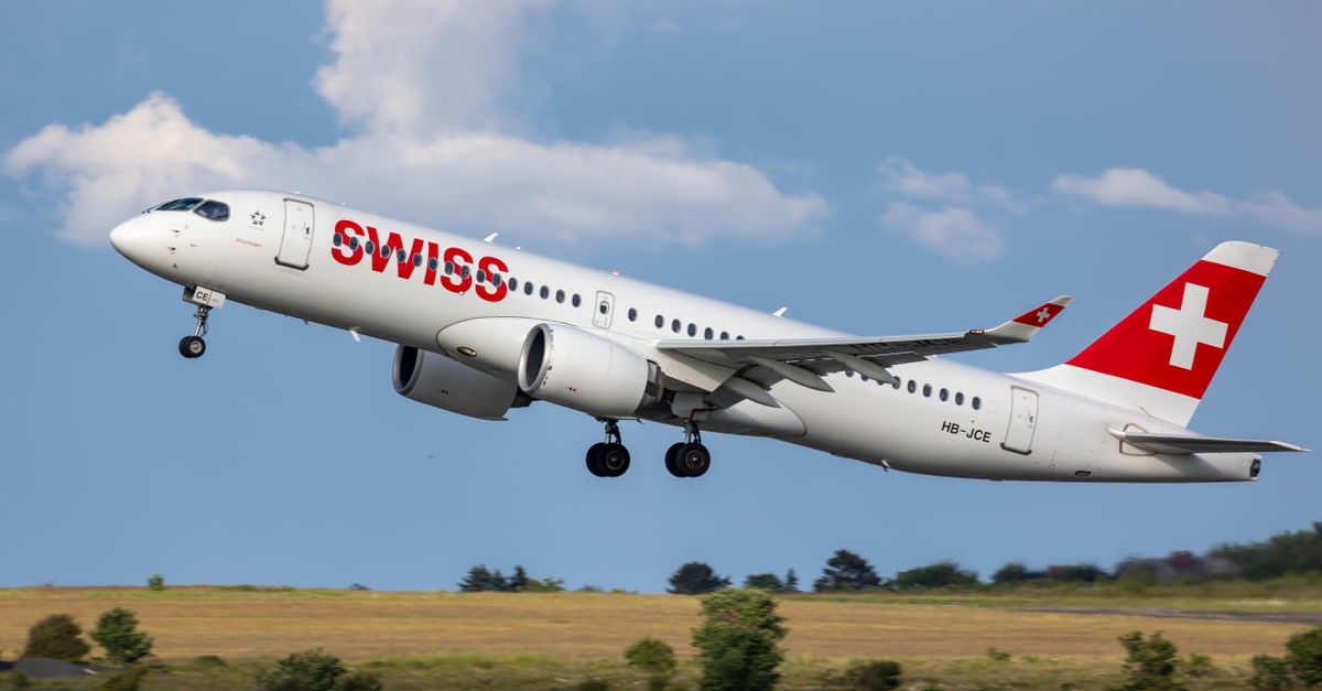Swiss International Airlines jet taking off from a runway under clear skies, showcasing aviation power.