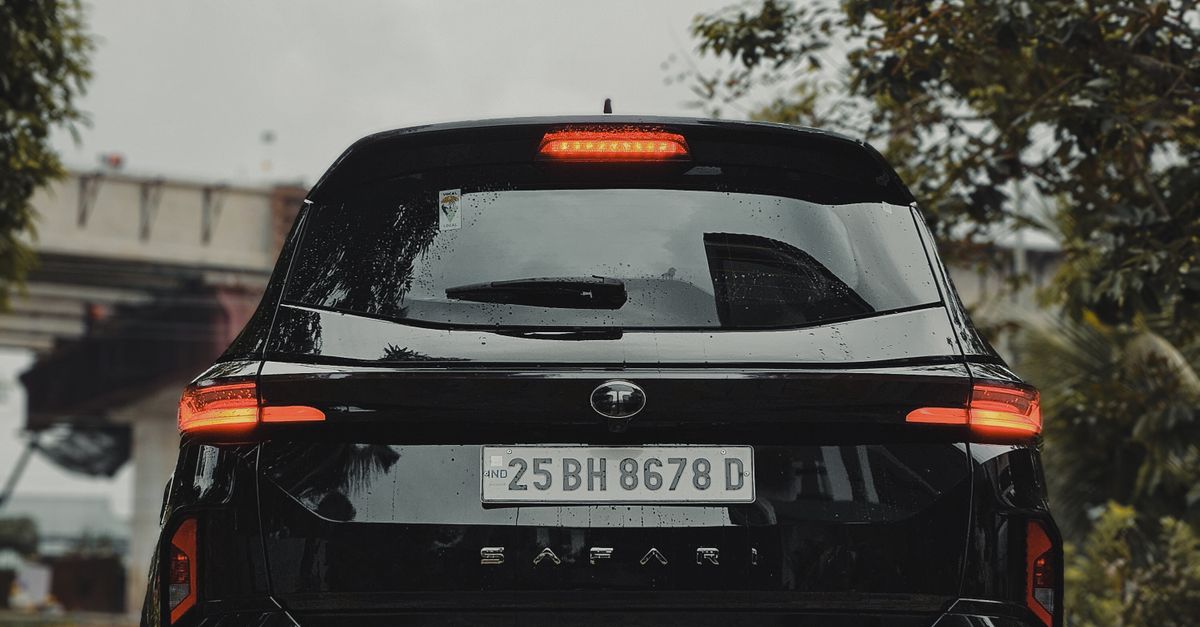 A sleek black SUV parked on a paved area with a cloudy sky backdrop, showcasing automotive elegance.