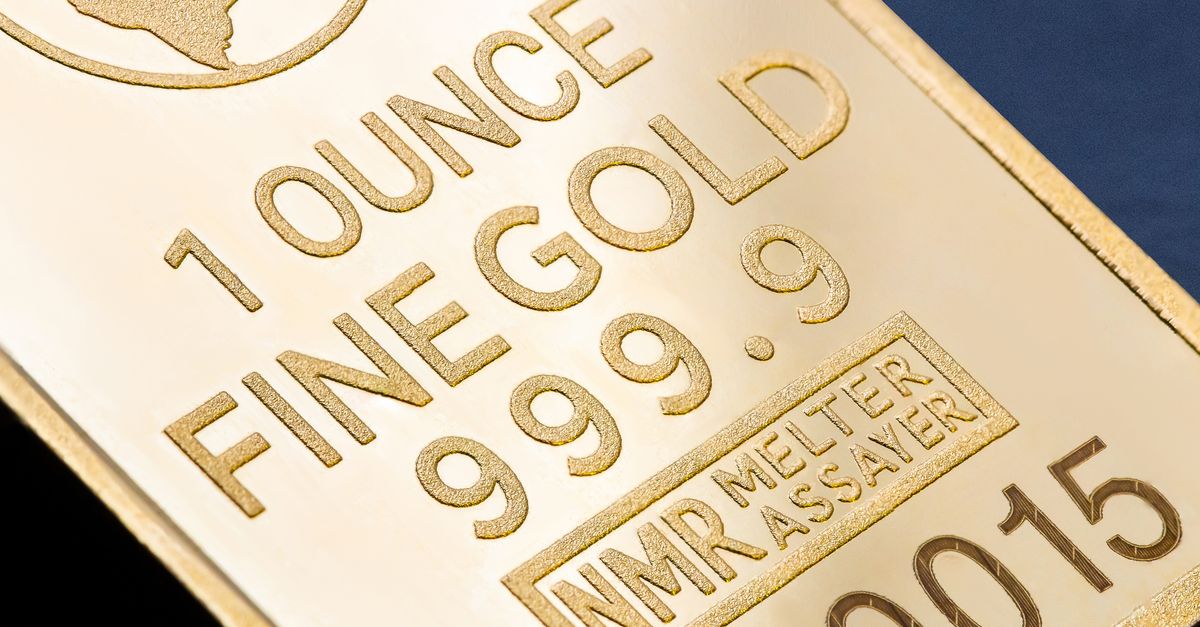 Detailed close-up of a 1 ounce fine gold bar with inscriptions, ideal for finance and investment themes.