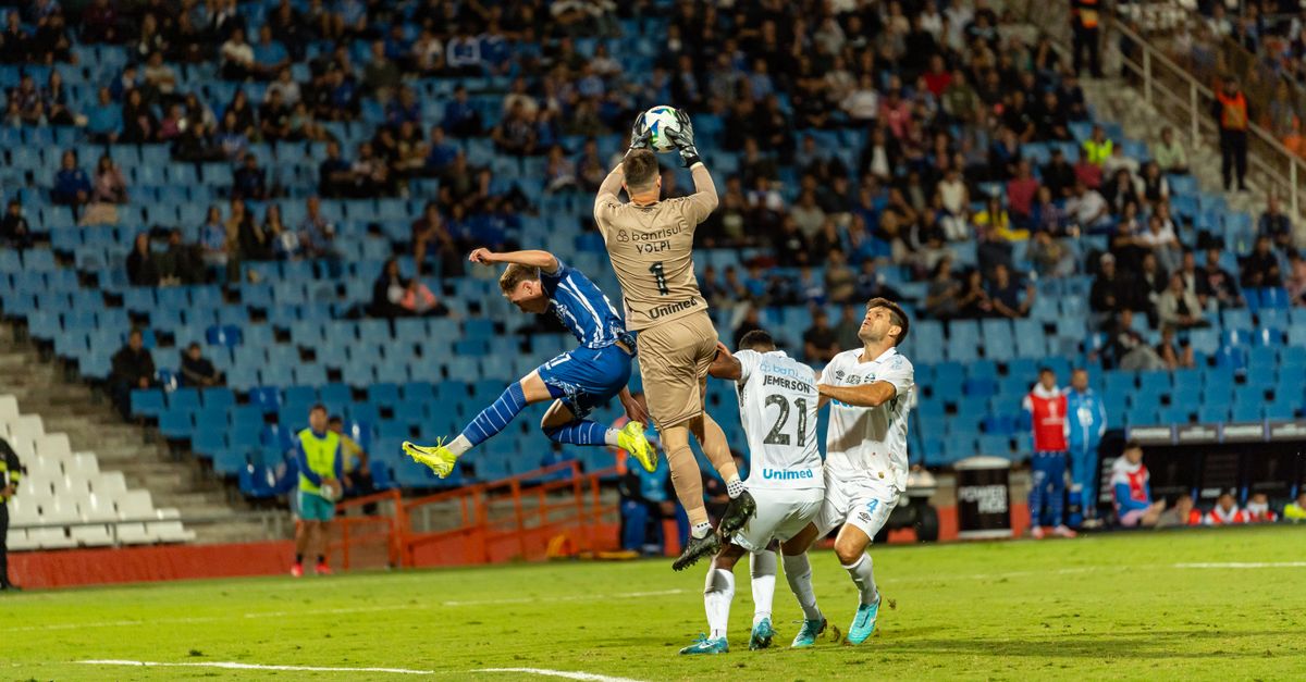 Football players in action during an intense match, capturing a dynamic stadium scene.