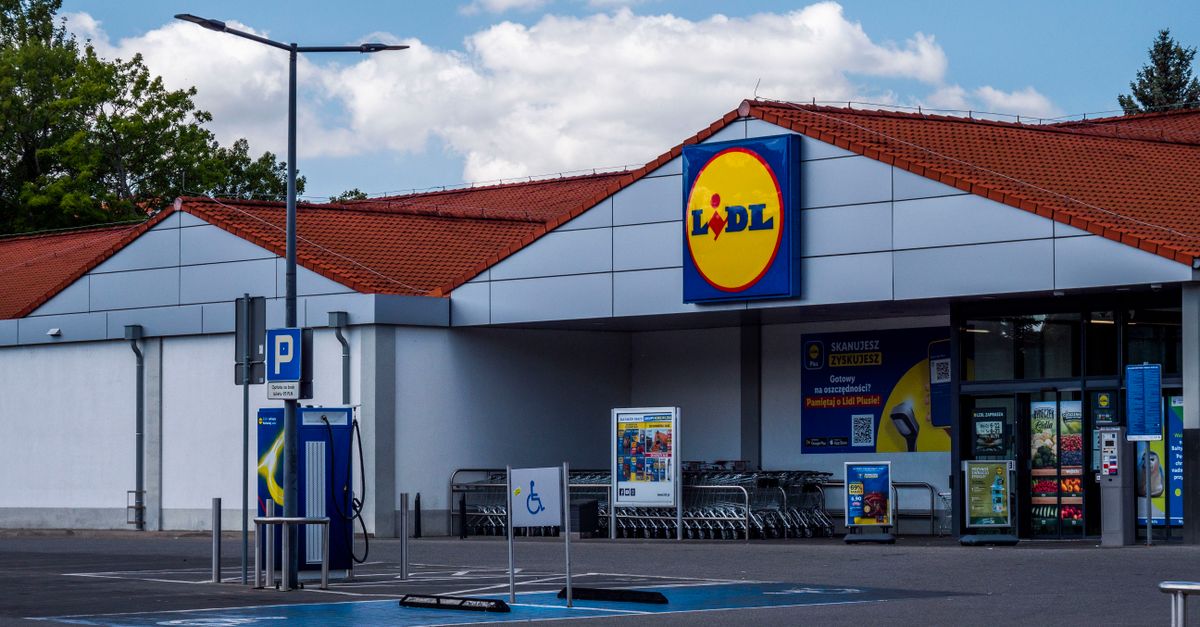 Lidl supermarket exterior featuring parking area and shopping carts on a sunny day.