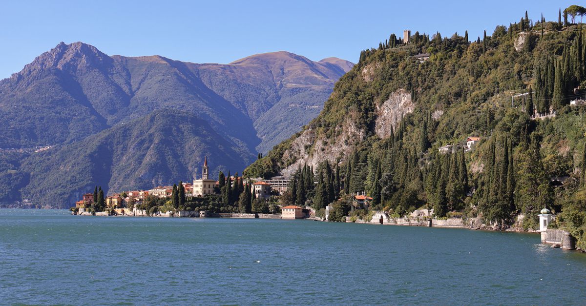 Scenic view of Lake Como with its calm waters and surrounding mountains in Varenna, Italy.