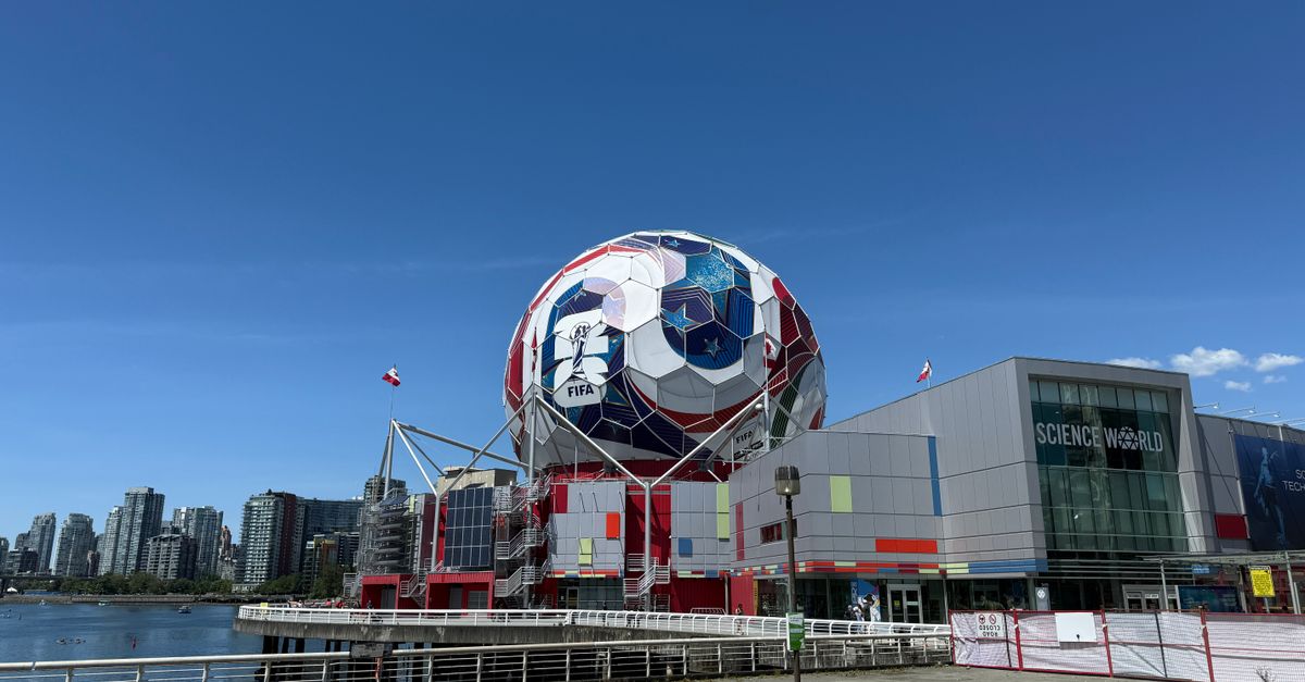 A vibrant view of Science World and surrounding cityscape in Vancouver with clear blue sky.