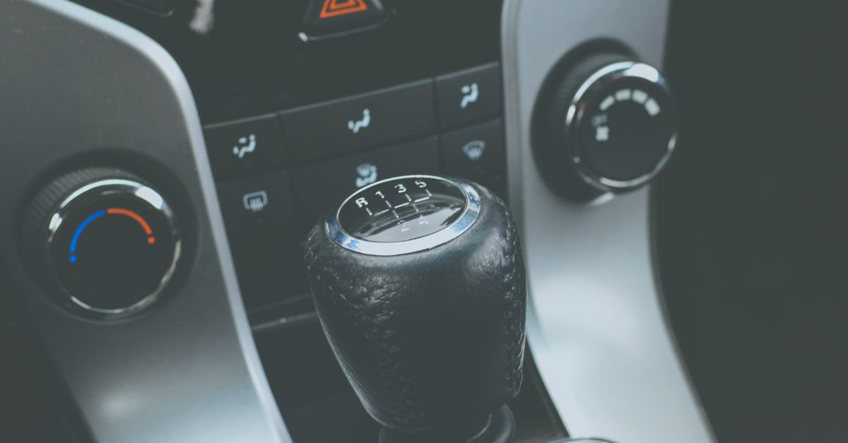 Detailed view of a manual gear shift knob and car console interior.