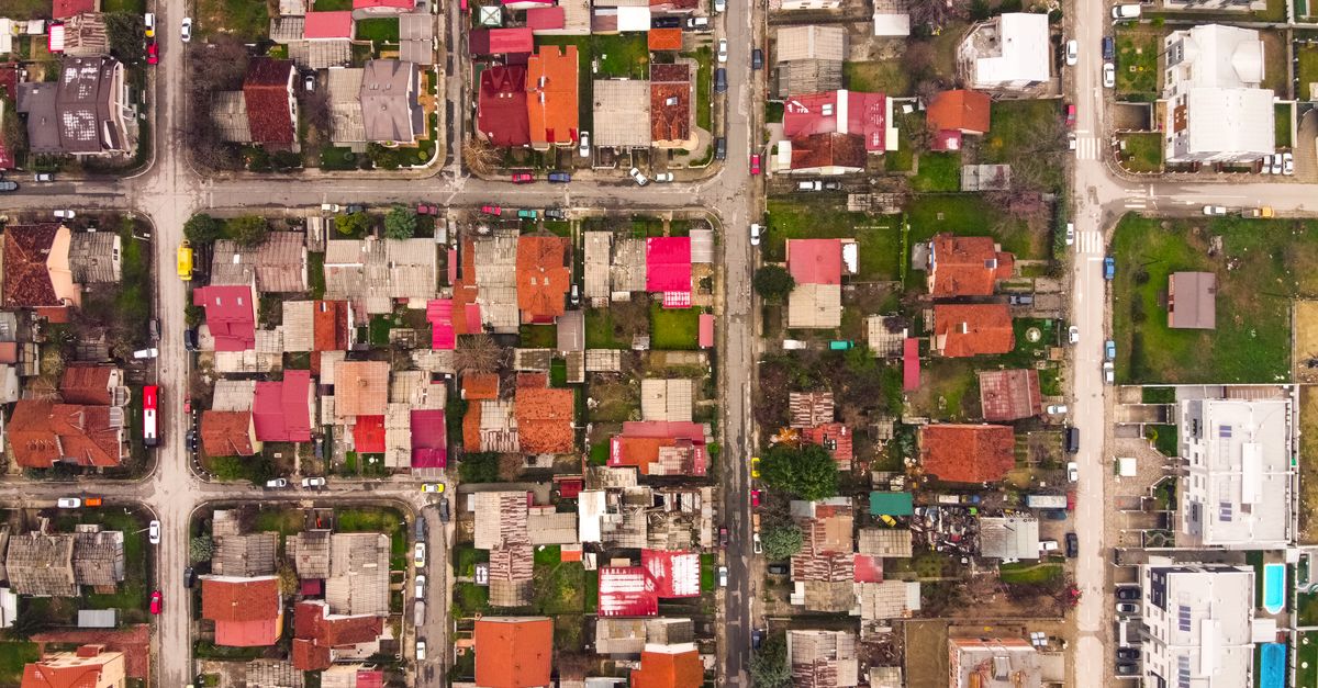 Vibrant aerial view of residential neighborhood in Lisiche, North Macedonia showcasing colorful rooftops and streets.