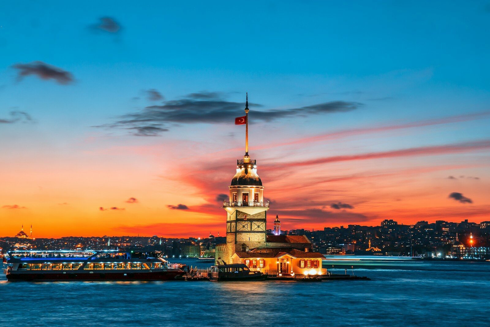 The Maiden Tower on the Bosphorus in Istanbul under a vibrant orange sky