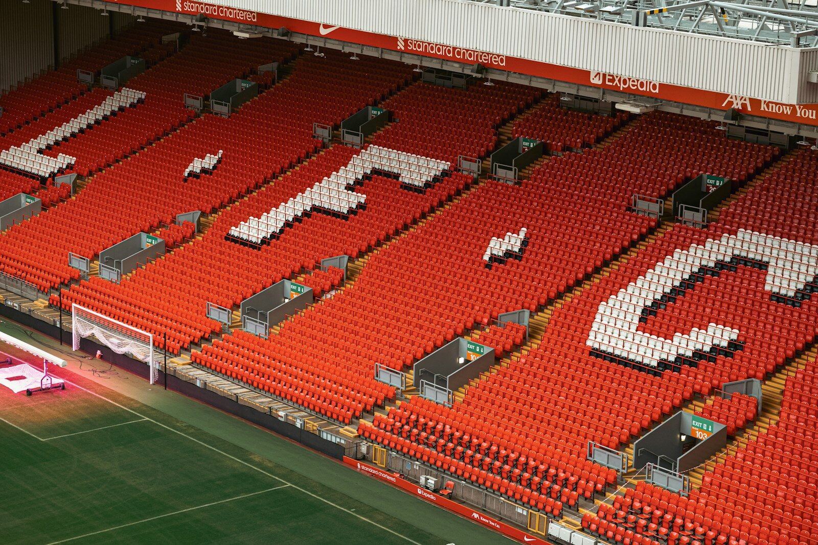 An empty stadium with a soccer field in the middle of it