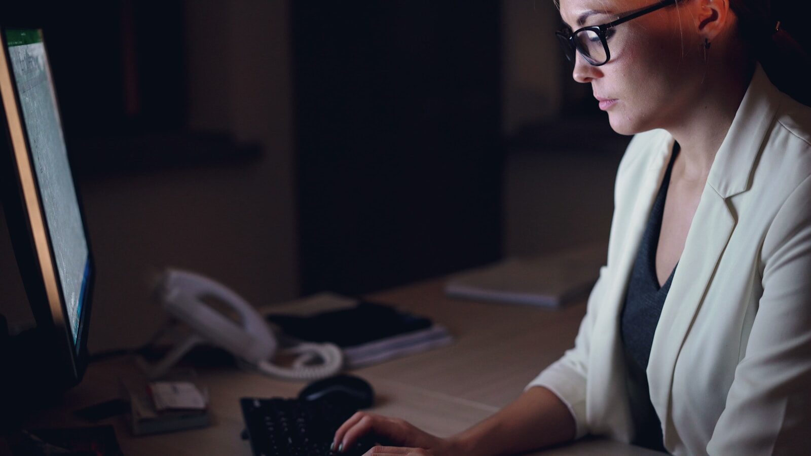 Woman working on computer at night