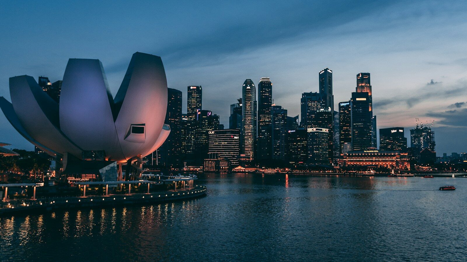The ArtScience Museum and Singapore skyline across the water at dusk